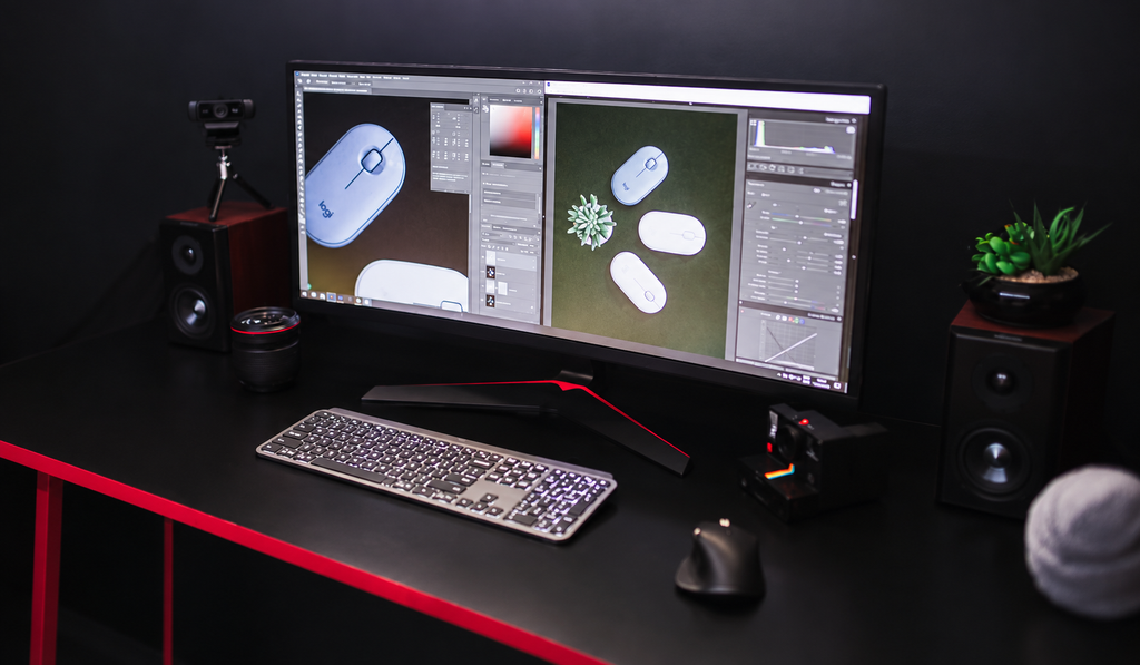 An empty control workstation with dual monitors in a dark operations room