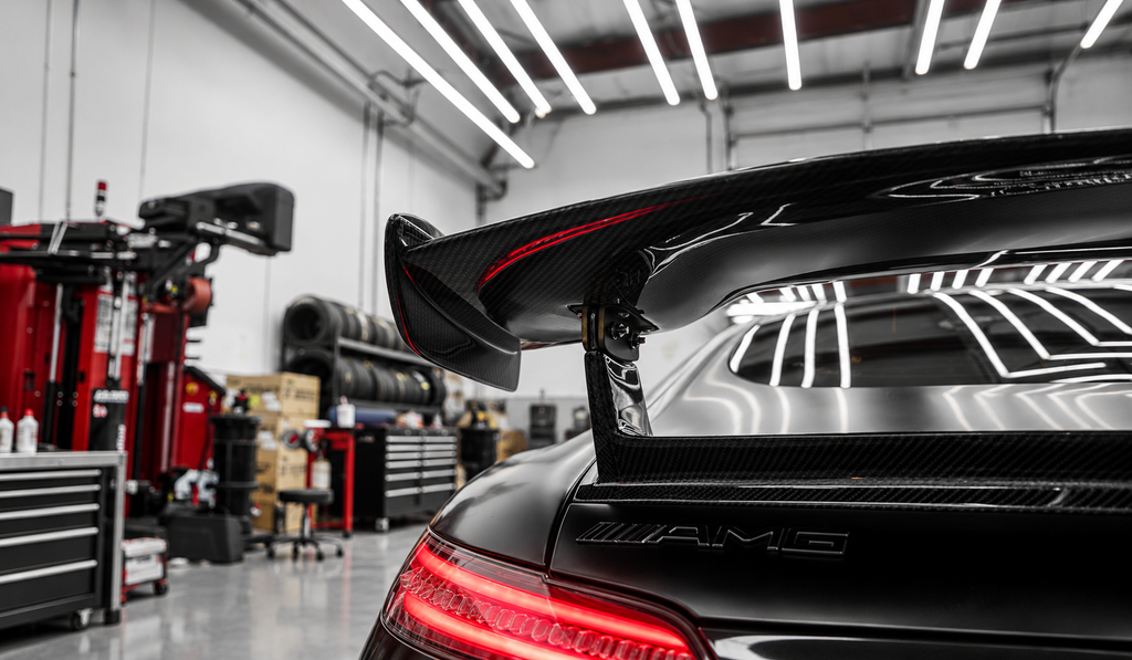 A rear wing viewed close up inside an automotive workshop